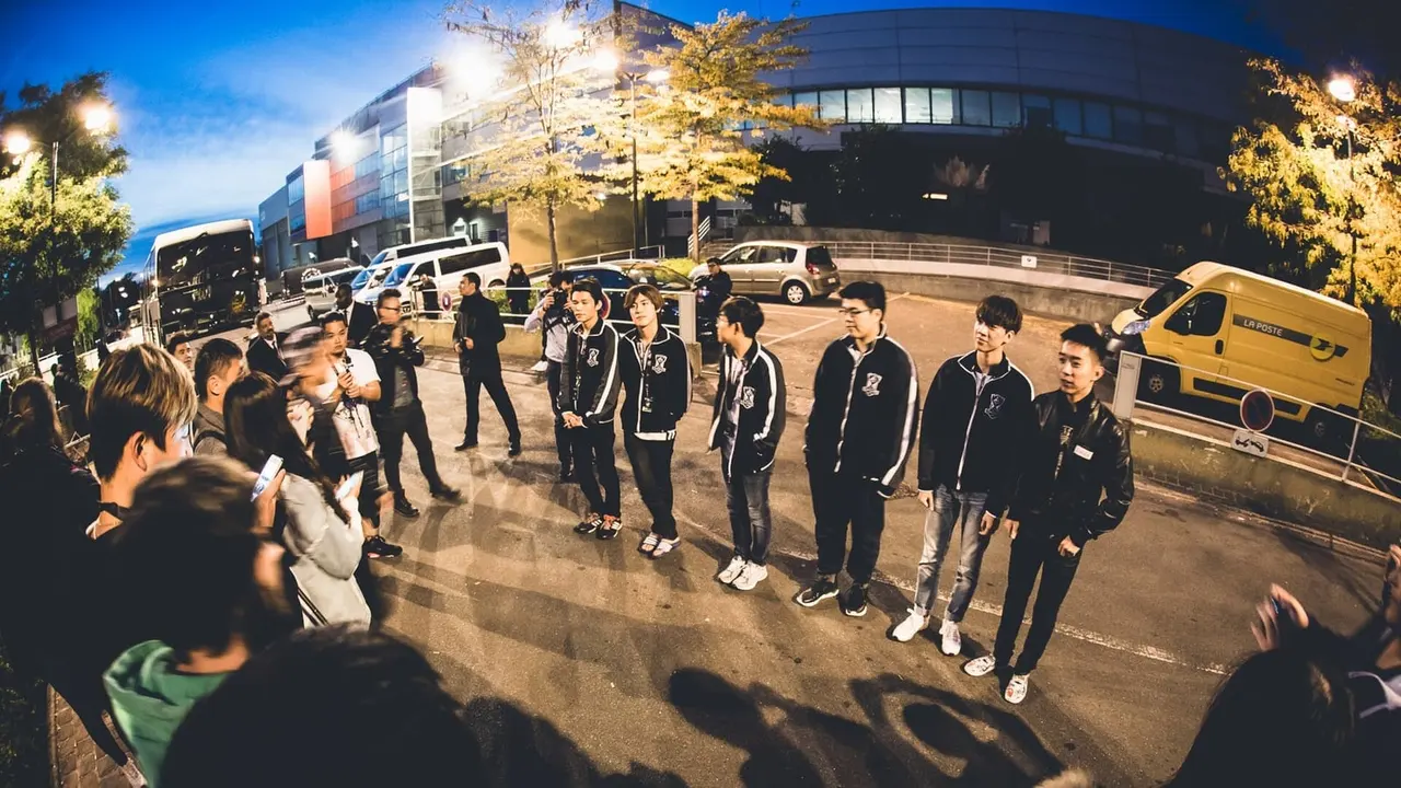 A League of Legends team in matching jackets meets fans outside the venue at the 2015 World Championship